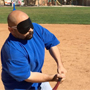 a blindfolded batter takes a swing at the plate.